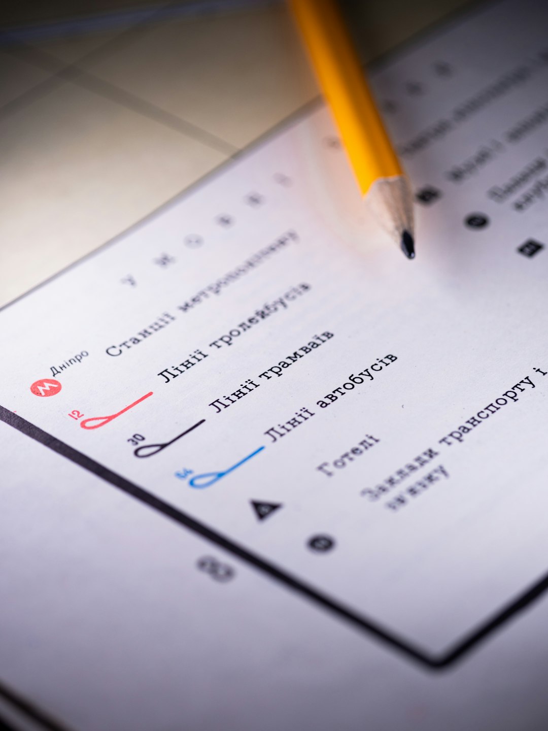 pencil-rests-on-a-detailed-map-with-transportation-lines-7s5z8jee4tg